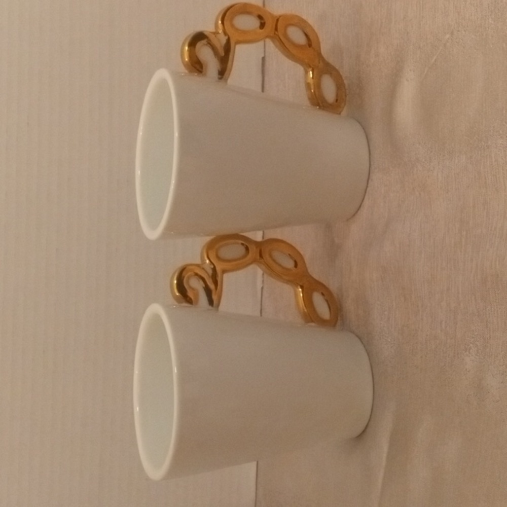White glossy Preowned Coffee Mugs with "2000" handle design.